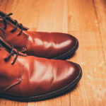 a pair of leather shoes on the floor